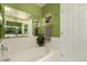 Relaxing bathroom with bathtub and built-in shelves at 553 S Meadows Dr, Chandler, AZ 85224