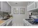 Modern kitchen with gray cabinets, gas range and double sink at 6125 E Indian School Rd # 180, Scottsdale, AZ 85251