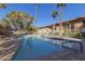 Community pool with plenty of lounge chairs and umbrellas at 6125 E Indian School Rd # 180, Scottsdale, AZ 85251