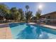 Inviting community pool with surrounding patio and chairs at 6125 E Indian School Rd # 180, Scottsdale, AZ 85251