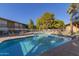 Community swimming pool with lounge chairs and patio area at 6125 E Indian School Rd # 180, Scottsdale, AZ 85251