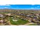 Aerial view of homes and golf course in a mountain setting at 6358 E Evening Glow Dr, Scottsdale, AZ 85266