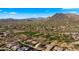 Aerial view of a luxury community with a golf course and mountain views at 6358 E Evening Glow Dr, Scottsdale, AZ 85266