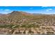 Aerial view of community with golf course and mountain range at 6358 E Evening Glow Dr, Scottsdale, AZ 85266