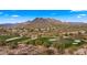 Aerial view of community with golf course and mountain backdrop at 6358 E Evening Glow Dr, Scottsdale, AZ 85266