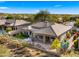 Aerial view of home with backyard patio, lawn, and mountain views at 6358 E Evening Glow Dr, Scottsdale, AZ 85266