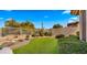 Landscaped backyard with artificial turf and desert landscaping at 6358 E Evening Glow Dr, Scottsdale, AZ 85266