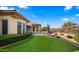 Landscaped backyard with artificial turf and a patio at 6358 E Evening Glow Dr, Scottsdale, AZ 85266