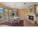 Charming dining area with fireplace and large windows at 6358 E Evening Glow Dr, Scottsdale, AZ 85266