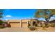 Two-car garage and desert landscaping with mountain views at 6358 E Evening Glow Dr, Scottsdale, AZ 85266