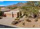 Tan colored house with a two-car garage and mountain views at 6358 E Evening Glow Dr, Scottsdale, AZ 85266