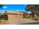 Two-car garage and desert landscaping with mountain views at 6358 E Evening Glow Dr, Scottsdale, AZ 85266