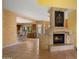 Living room fireplace with a view into the kitchen at 6358 E Evening Glow Dr, Scottsdale, AZ 85266