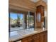 Kitchen with granite countertops, wood cabinets, and a view of the backyard at 6358 E Evening Glow Dr, Scottsdale, AZ 85266