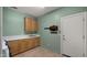 Laundry room with wood cabinets, sink, and built-in storage at 6358 E Evening Glow Dr, Scottsdale, AZ 85266