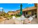 Relaxing patio with seating area, umbrella, and desert landscaping at 6358 E Evening Glow Dr, Scottsdale, AZ 85266