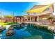 Stunning backyard oasis with pool, pergola, and shade sails at 6414 W Villa Linda Dr, Glendale, AZ 85310