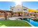 Attractive backyard with a pool, pergola, and shade sails at 6414 W Villa Linda Dr, Glendale, AZ 85310