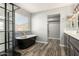 Modern bathroom with freestanding tub and walk-in shower at 6414 W Villa Linda Dr, Glendale, AZ 85310