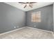 Well-lit bedroom featuring a ceiling fan and carpet at 6414 W Villa Linda Dr, Glendale, AZ 85310