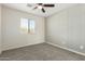 Bedroom with ceiling fan, window, and patterned wall at 6414 W Villa Linda Dr, Glendale, AZ 85310