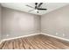 Bright bedroom with ceiling fan and laminate wood flooring at 6414 W Villa Linda Dr, Glendale, AZ 85310