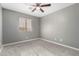 Bright bedroom with window, ceiling fan and carpet at 6414 W Villa Linda Dr, Glendale, AZ 85310