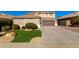 Two-story house with artificial turf and a large driveway at 6414 W Villa Linda Dr, Glendale, AZ 85310