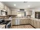 Modern kitchen with light cabinets, stainless steel appliances and an island at 6414 W Villa Linda Dr, Glendale, AZ 85310