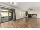 Living room with hardwood floors, fireplace, and sliding glass doors at 6414 W Villa Linda Dr, Glendale, AZ 85310