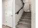 Carpeted staircase with a simple handrail and white door at 6414 W Villa Linda Dr, Glendale, AZ 85310