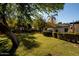 Spacious backyard with grassy area and mature trees at 6740 N 7Th St, Phoenix, AZ 85014