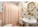 Charming bathroom with floral wallpaper and pedestal sink at 6740 N 7Th St, Phoenix, AZ 85014