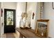 Inviting entryway with a wooden console table and large mirror at 6740 N 7Th St, Phoenix, AZ 85014