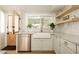 Kitchen with white cabinets, a farmhouse sink, and wood door at 6740 N 7Th St, Phoenix, AZ 85014