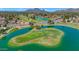 Aerial view of golf course with lake and mountains at 7258 E Manzanita Dr, Scottsdale, AZ 85258