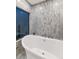 Bathroom with a free-standing bathtub and large window at 7258 E Manzanita Dr, Scottsdale, AZ 85258