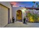 View of the entryway with arched passage and decorative pots at 7258 E Manzanita Dr, Scottsdale, AZ 85258