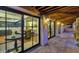 View of patio and kitchen through glass doors at night at 7258 E Manzanita Dr, Scottsdale, AZ 85258