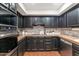 Well-equipped kitchen with dark cabinetry and stainless steel appliances at 7258 E Manzanita Dr, Scottsdale, AZ 85258