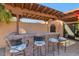 Outdoor kitchen with brick counter and pergola at 7258 E Manzanita Dr, Scottsdale, AZ 85258