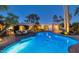 Night view of a freeform pool with surrounding patio and seating area at 7258 E Manzanita Dr, Scottsdale, AZ 85258