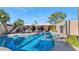 Daytime view of a freeform pool with patio furniture and a grilling area at 7258 E Manzanita Dr, Scottsdale, AZ 85258