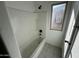 Clean bathroom with a bathtub, shower, and window at 7827 W Cypress St, Phoenix, AZ 85035