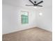 Spacious bedroom with ceiling fan and carpet at 7827 W Cypress St, Phoenix, AZ 85035