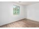 Bright bedroom with light wood floors and a window at 7827 W Cypress St, Phoenix, AZ 85035