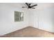 Well-lit bedroom with ceiling fan and window at 7827 W Cypress St, Phoenix, AZ 85035