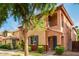 Two-story house with a balcony and a tree in the front at 7827 W Cypress St, Phoenix, AZ 85035