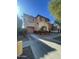 Two-story house with tan and red exterior, two-car garage, and landscaping at 7827 W Cypress St, Phoenix, AZ 85035