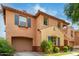 Tan two-story house with a large garage and palm trees at 7827 W Cypress St, Phoenix, AZ 85035